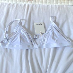 A white Bikini top with adjustable straps .